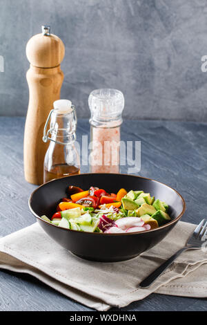 Vegan buddha bowl. Healthy vegetarian salad with cherry tomatoes, cucumber, radish,, avocado and lettuce. Stock Photo