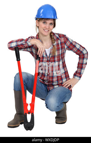 Craftswoman holding a huge spanner Stock Photo