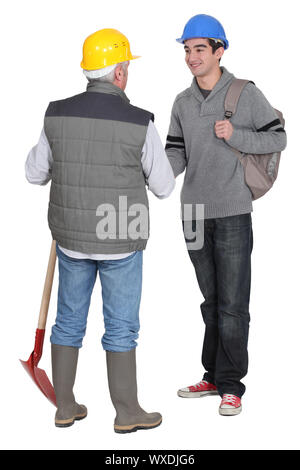 Experienced tradesman meeting his new apprentice for the first time Stock Photo