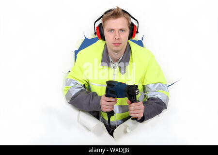 Worker wearing reflective jacket and drill Stock Photo