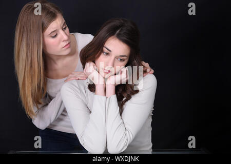 Woman consoling distraught girl Stock Photo