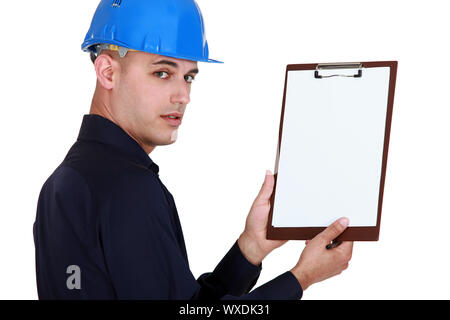 Man in hard-had holding clip-board Stock Photo