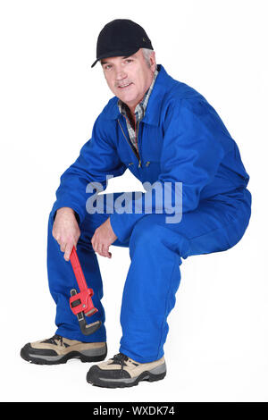 Middle-aged plumber sat down Stock Photo