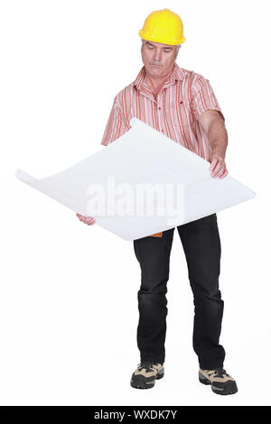 senior craftsman looking at a blueprint Stock Photo - Alamy