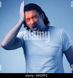 Man suffering from acute headache Stock Photo