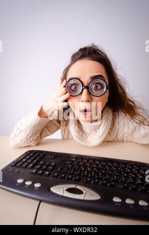 Funny nerd girl working on computer Stock Photo