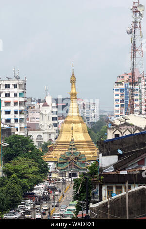 Shwedagon Pagoda on A busy city street Yangon City, Myanmar Stock Photo