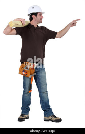 carpenter in profile holding lumber pointing at someone Stock Photo