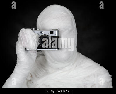 Photographer - mummy on the black background isolated Stock Photo
