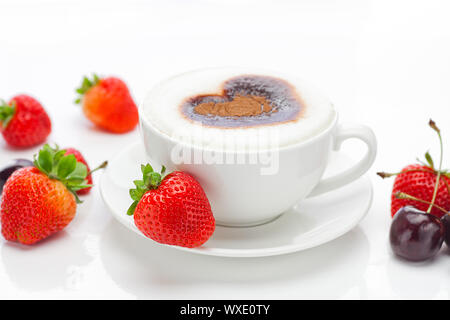 cappuccino in a cup in the shape of hearts,cherry  and strawberries isolated on white Stock Photo
