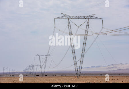 High voltage lines and power pylons Stock Photo