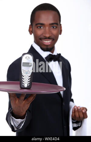 Waiter with a cellphone on a tray Stock Photo