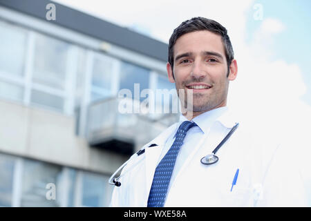 Doctor stood outside hospital Stock Photo