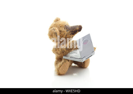 teddy bear and miniature laptop  isolated on white Stock Photo