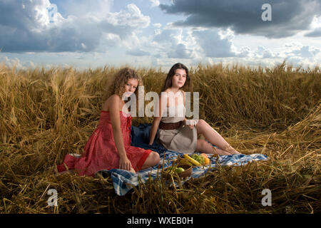 Two beautiful slavonic girls on picnic in wheat field Stock Photo - Alamy