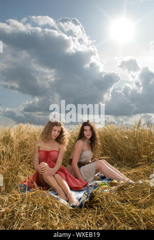 Two beautiful slavonic girls on picnic in wheat field Stock Photo - Alamy