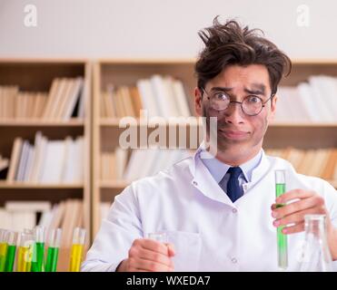 Mad crazy scientist doctor doing experiments in a laboratory Stock Photo