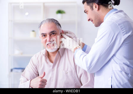Male patient with hearing problem visiting doctor otorhinolaryng Stock Photo