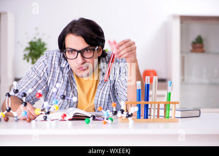 Young student physicist preparing for exam at home Stock Photo