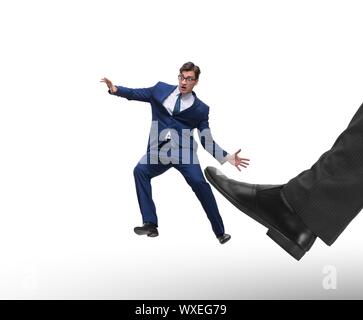 Bad angry boss kicking employee in business concept Stock Photo