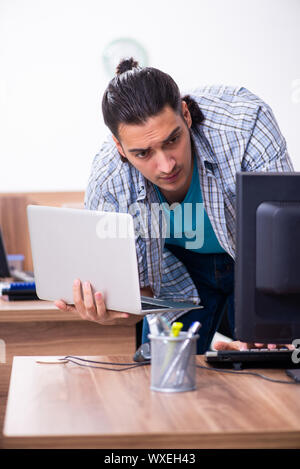 Young male it specialist in the office Stock Photo