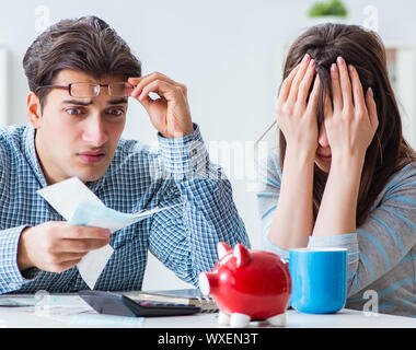 Young couple looking at family finance papers Stock Photo