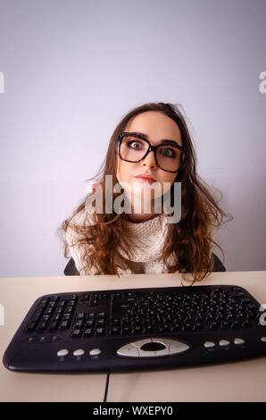Funny nerd girl working on computer Stock Photo