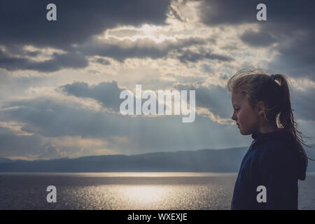 Little young girl by the lake portrait Stock Photo