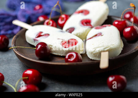 Artisanal vanilla sundae with red cherry. Stock Photo