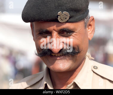 PUSHKAR, INDIA - NOVEMBER 21: Portrait of a police officer on the Pushkar fair on November 21, 2012 in Pushkar, Rajasthan, India. Stock Photo