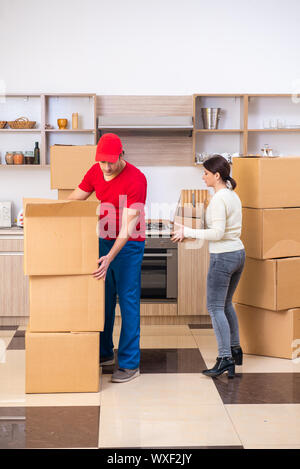 Young male contractor and female customer in moving concept Stock Photo