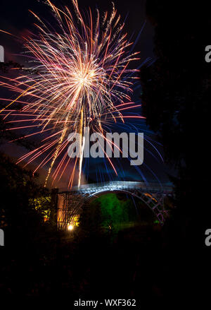 Fireworks over the iron bridge in Shropshire, England  as part of a celebration. Stock Photo