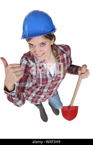 young female bricklayer holding shovel Stock Photo
