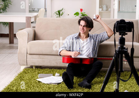 Young guitar player recording video for his blog Stock Photo