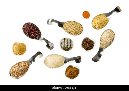 BEANS RICE BUCKWHEAT SEEDS LENTILS SPICES IN SPOONS ON THE ISOLATE Stock Photo