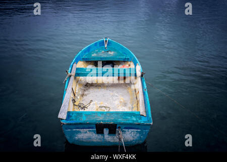 Small blue wooden rowing fisherman boat