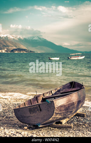 Old wooden fishing boat landing on the beach Stock Photo - Alamy