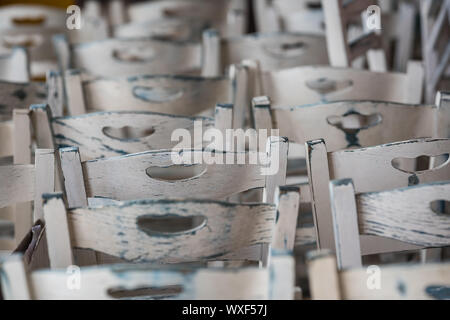 Row of empty white wooden chairs Stock Photo