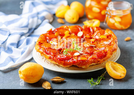 Apricot tarte tatin pie with thyme and almonds. Stock Photo