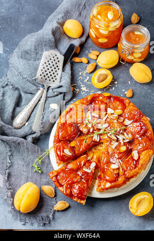 Sliced caramelized tarte tatin pie with apricots. Stock Photo