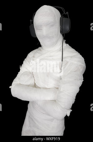 Man in bandage with ear-phones on black Stock Photo