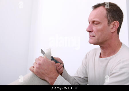 Man cutting carpet Stock Photo