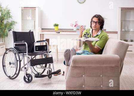 Young male student in wheelchair at home Stock Photo