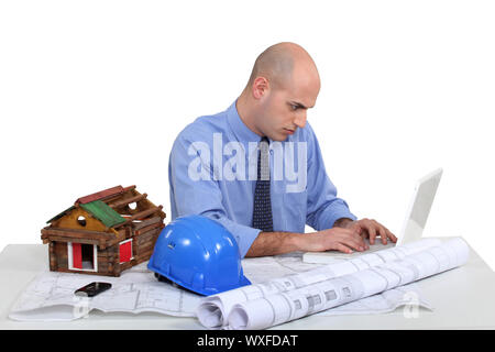 Architect sat at desk Stock Photo