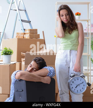 Young family unpacking at new house with boxes Stock Photo