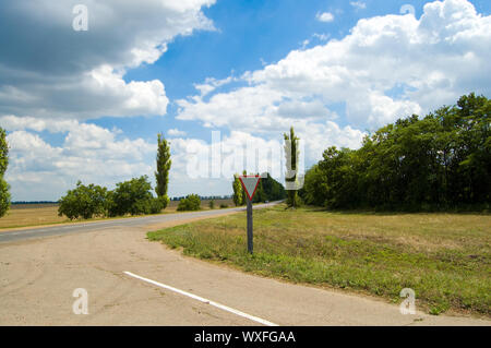 covered second way with road sign and clouds Stock Photo