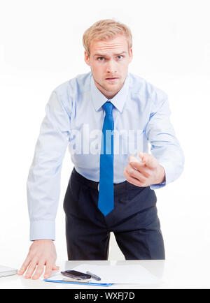 angry boss standing behind desk, gesticulating, accusing, blaming Stock Photo