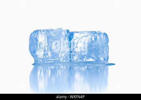 ice cubes shot on reflective white surface Stock Photo