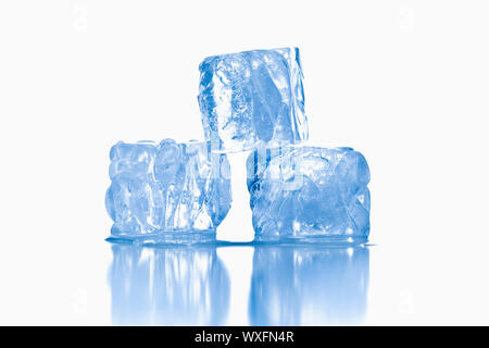 ice cubes shot on reflective white surface Stock Photo