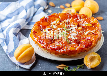 Apricot tarte tatin pie with thyme and almonds. Stock Photo